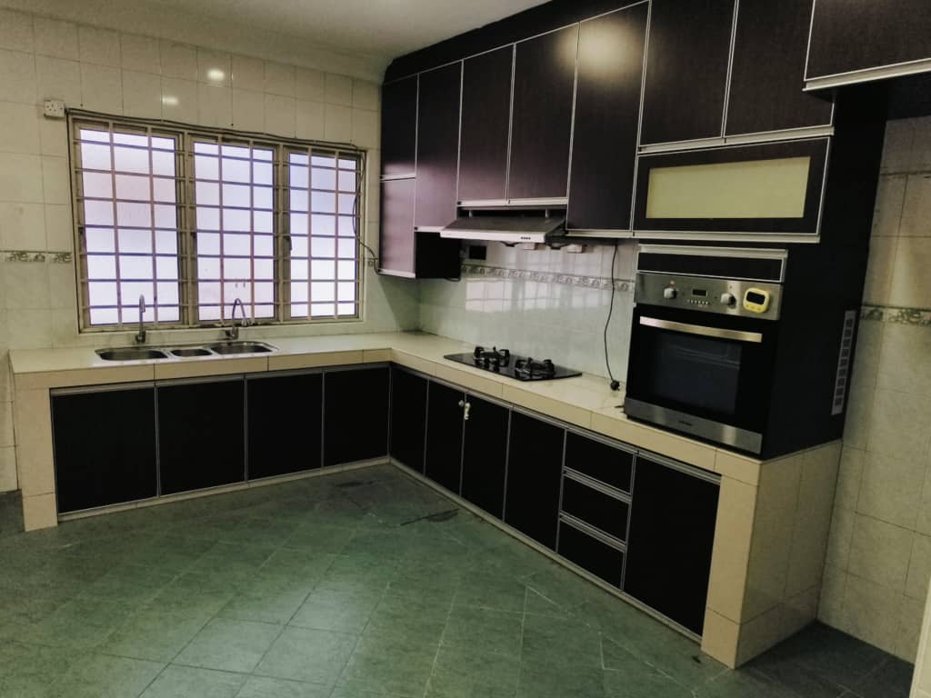 L-shaped fitted kitchen with dark cabinets and built-in oven